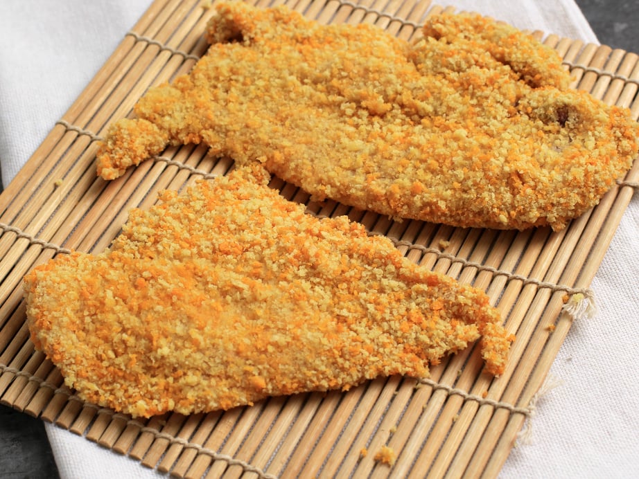 Breaded Chicken Cutlet or Chicken Katsu over a Bamboo Board