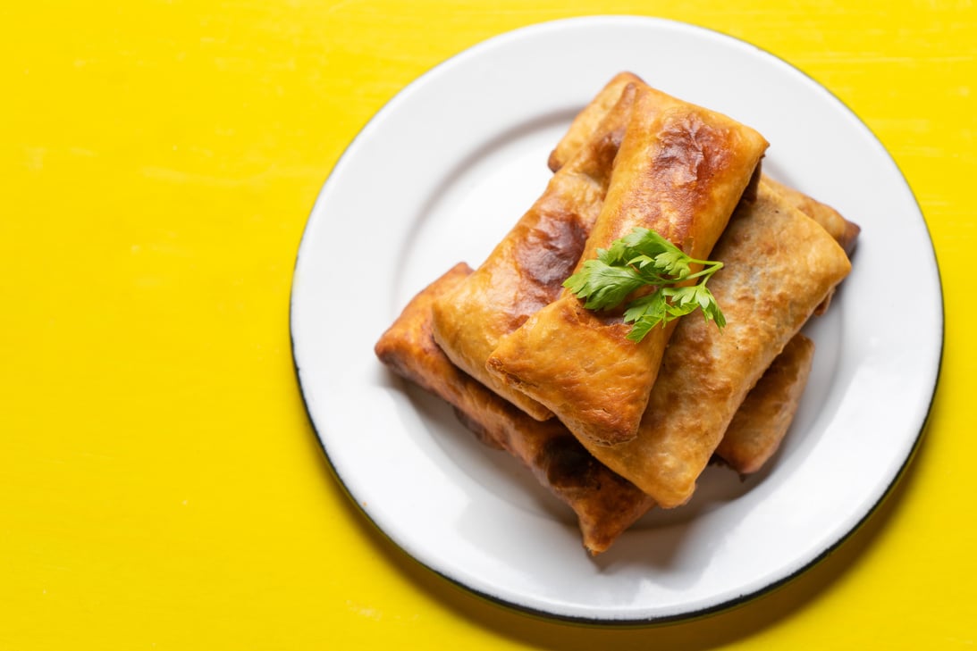 Mexican chimichanga on yellow background