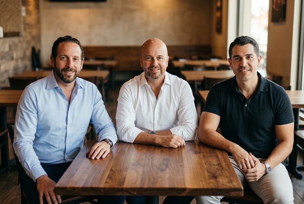 Founders Ricardo, Alejandro and Omar seated together at a restaurant table